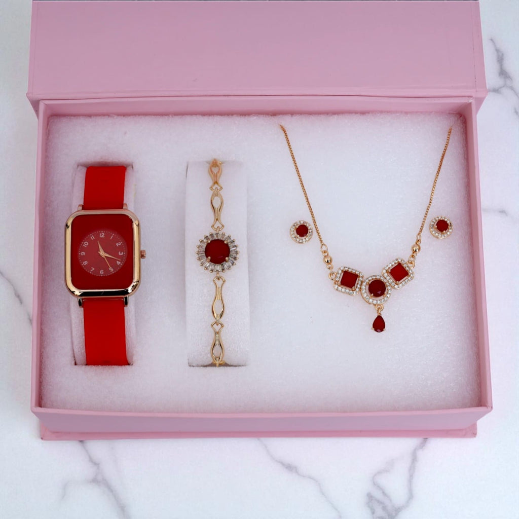 Elegant red women's gift set including watch, bracelet, necklace and earrings in pink box on marble surface