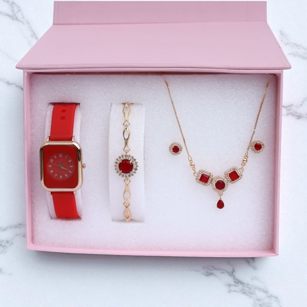 Red women's gift set with watch, bracelet, necklace and earrings in open pink box on marble background