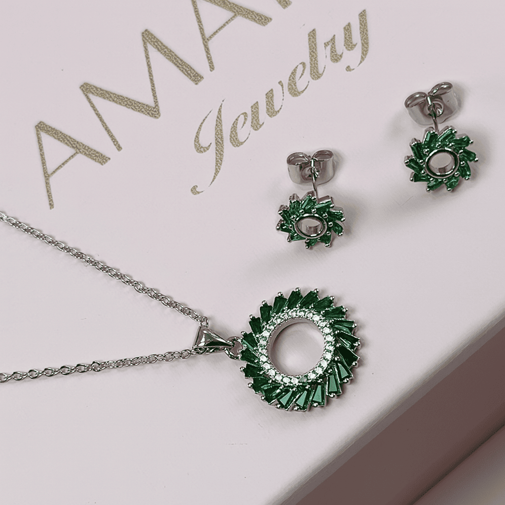 Elegant green halo pendant necklace and stud earrings set with emerald green stones displayed on white Amariz Jewelry box with logo