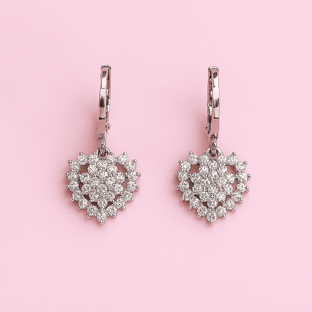 Elegant heart-shaped zircon earrings pair with cubic zirconia displayed on pink background