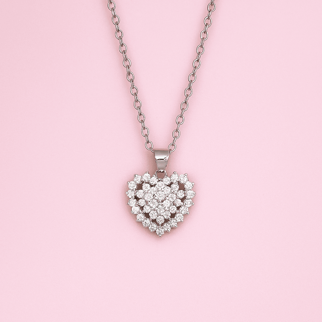 Elegant heart-shaped zircon pendant with cubic zirconia stones on silver chain displayed on pink background