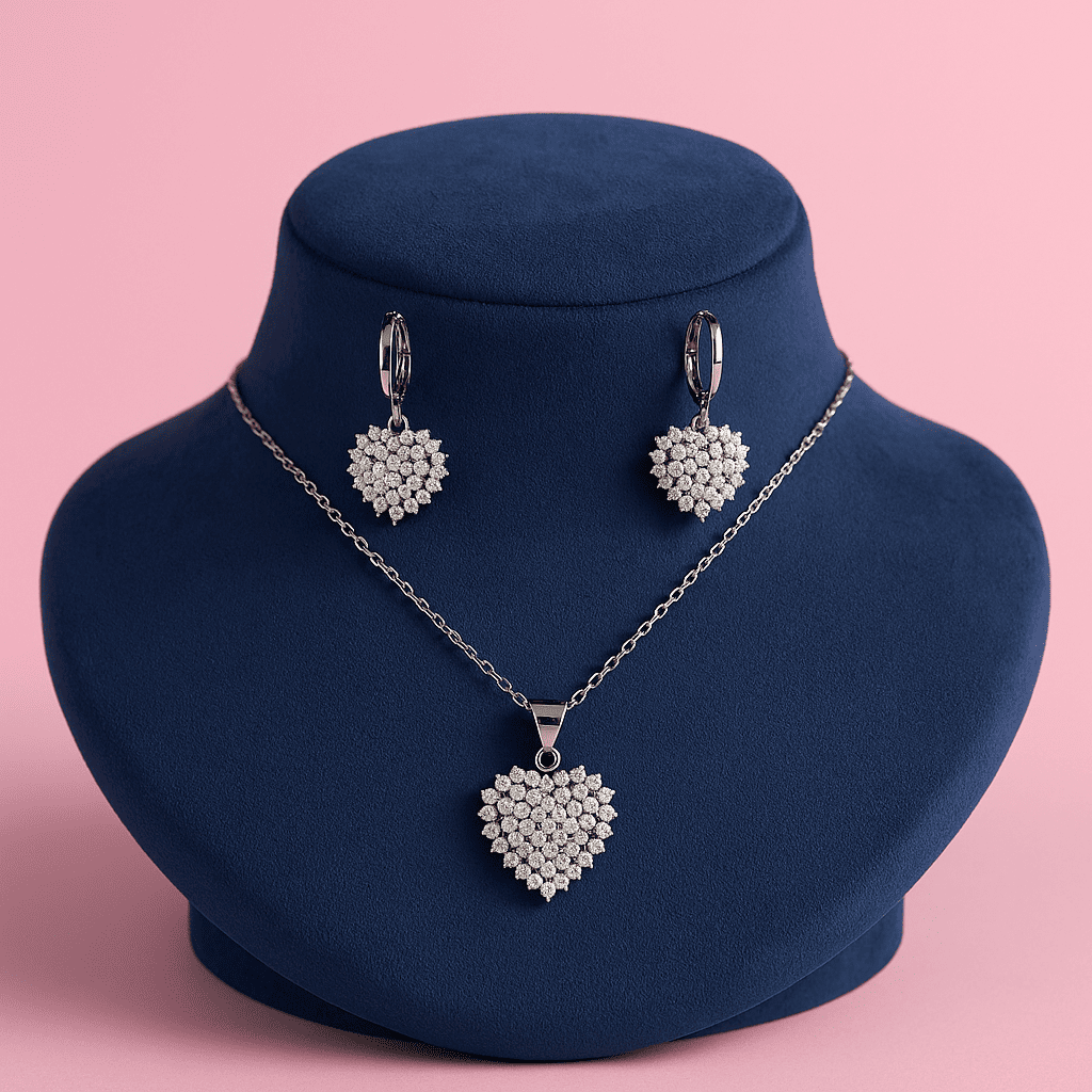 Elegant heart-shaped zircon necklace and earrings set displayed on blue velvet bust stand against pink background