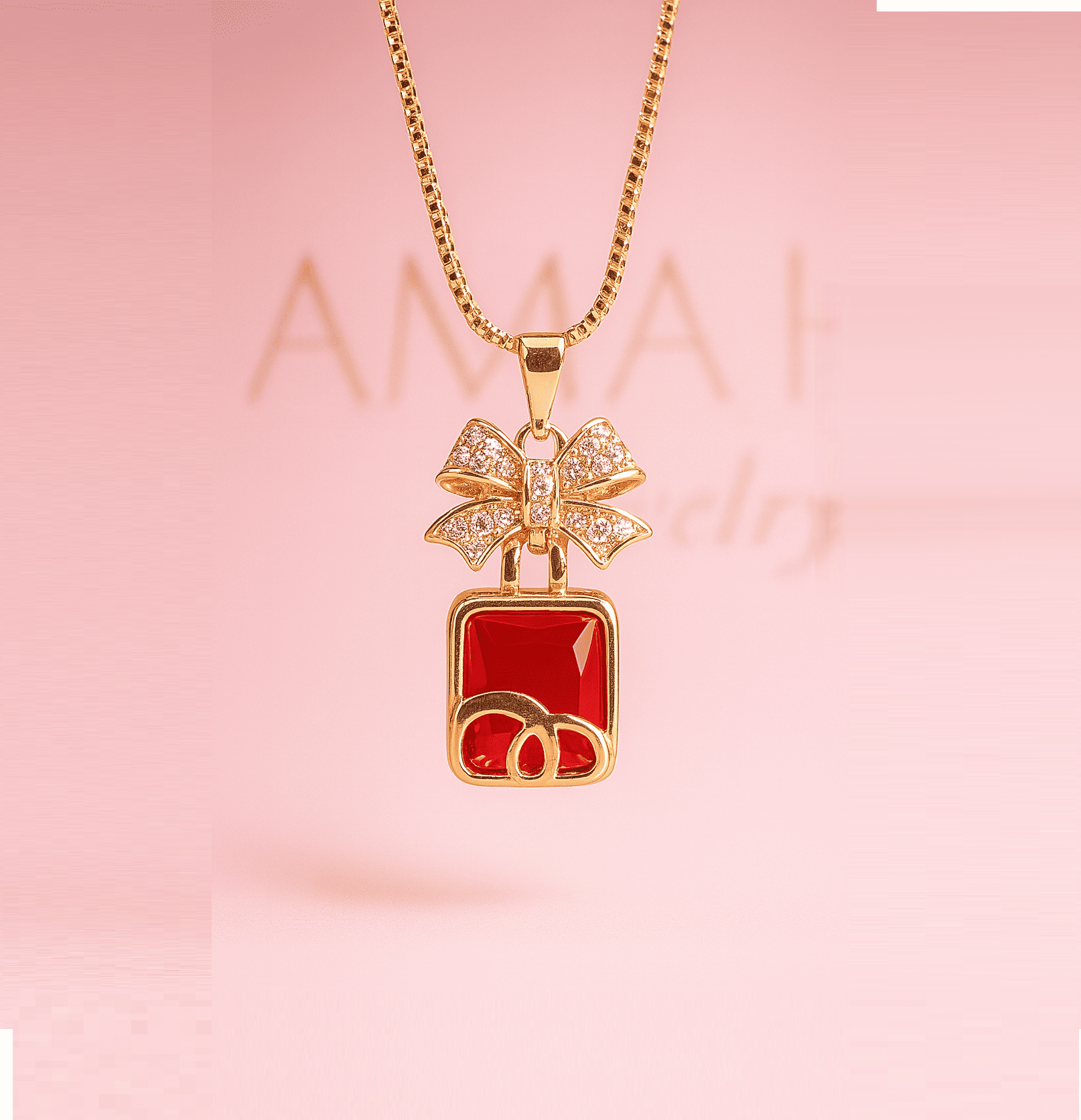 Gold necklace with red square pendant and bow design on pink background